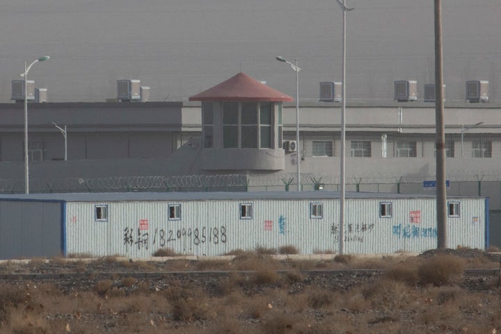 In this Monday, Dec. 3, 2018, photo, a guard tower and barbed wire fences are seen around a facility in the Kunshan Industria