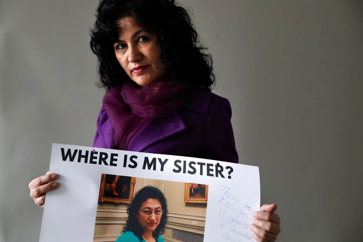 Rushan Abbas, 51, of Herndon, Va., holds a photo of her sister, Gulshan Abbas, Monday, Dec. 17, 2018, in Washington. Rushan Abbas, a Uighur in Washington, D.C., said her sister is among the many Uighurs detained. The sister, Dr. Gulshan Abbas was taken to what the government calls a vocational center, although she has no specific information on whether her sister is being forced to work.