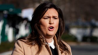 White House press secretary Sarah Huckabee Sanders talks with reporters outside the White House, Tuesday, Dec. 18, 2018, in Washington. (AP Photo/Evan Vucci)