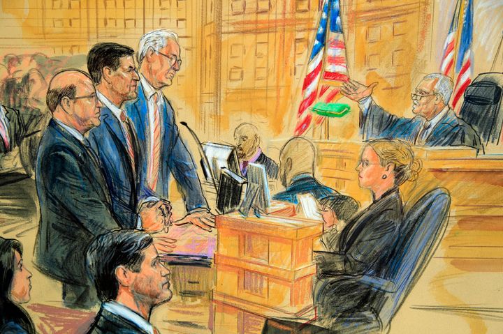 This courtroom sketch depicts former President Donald Trump's former national security adviser Michael Flynn, standing centre, flanked by his lawyers, listening to US District Judge Emmet Sullivan, right.