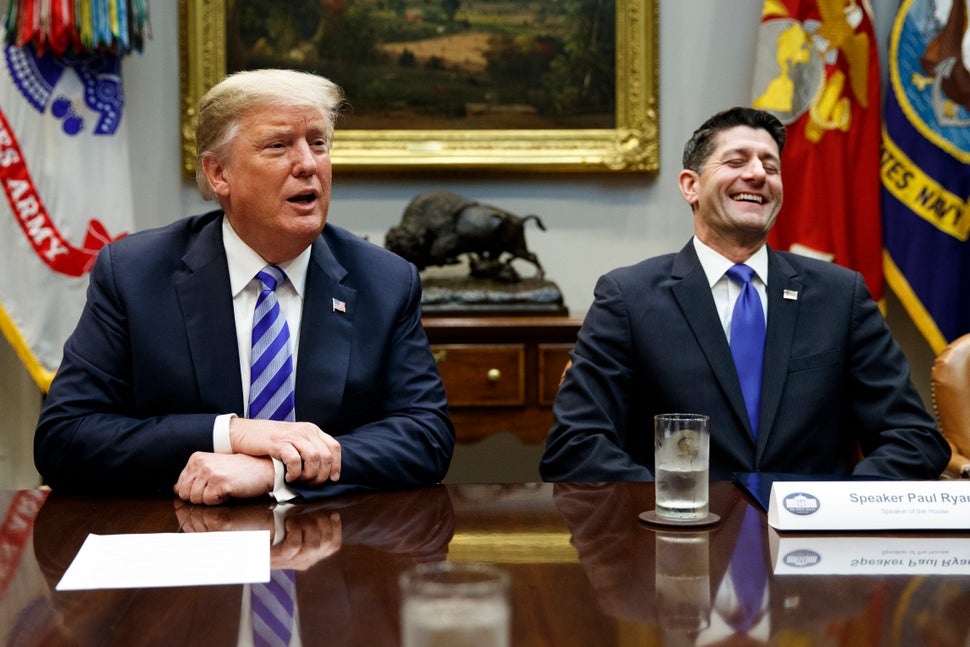 Speaker of the House Paul Ryan (R-Wis.) laughs as he listens to President Donald Trump speak during a meeting with Republican