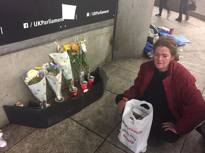 <strong>Homeless woman Jamie Leigh sits by a shrine to her friend who died just metres from the entrance to Westminster on Tuesday night </strong>