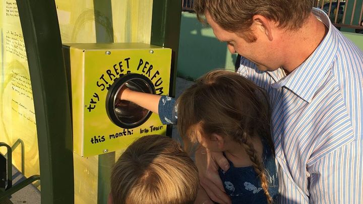 At a Los Angeles bus shelter, a family tries out a “perfume box” created by a local artist embedded with the city’s transportation department last year. 