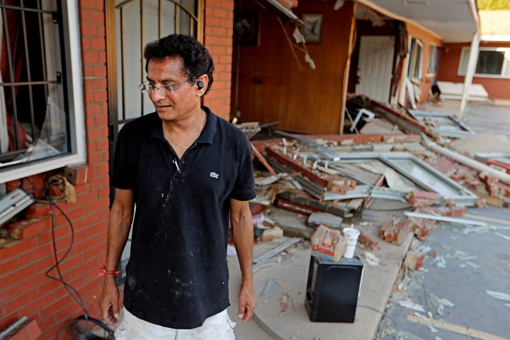 Kishor Depani sorts through damage at the motel he co-owns in Spring Lake, North Carolina, after flooding from Hurricane Florence in September. A recent Congressional Budget Office report minimized the effects of climate change on the economy.