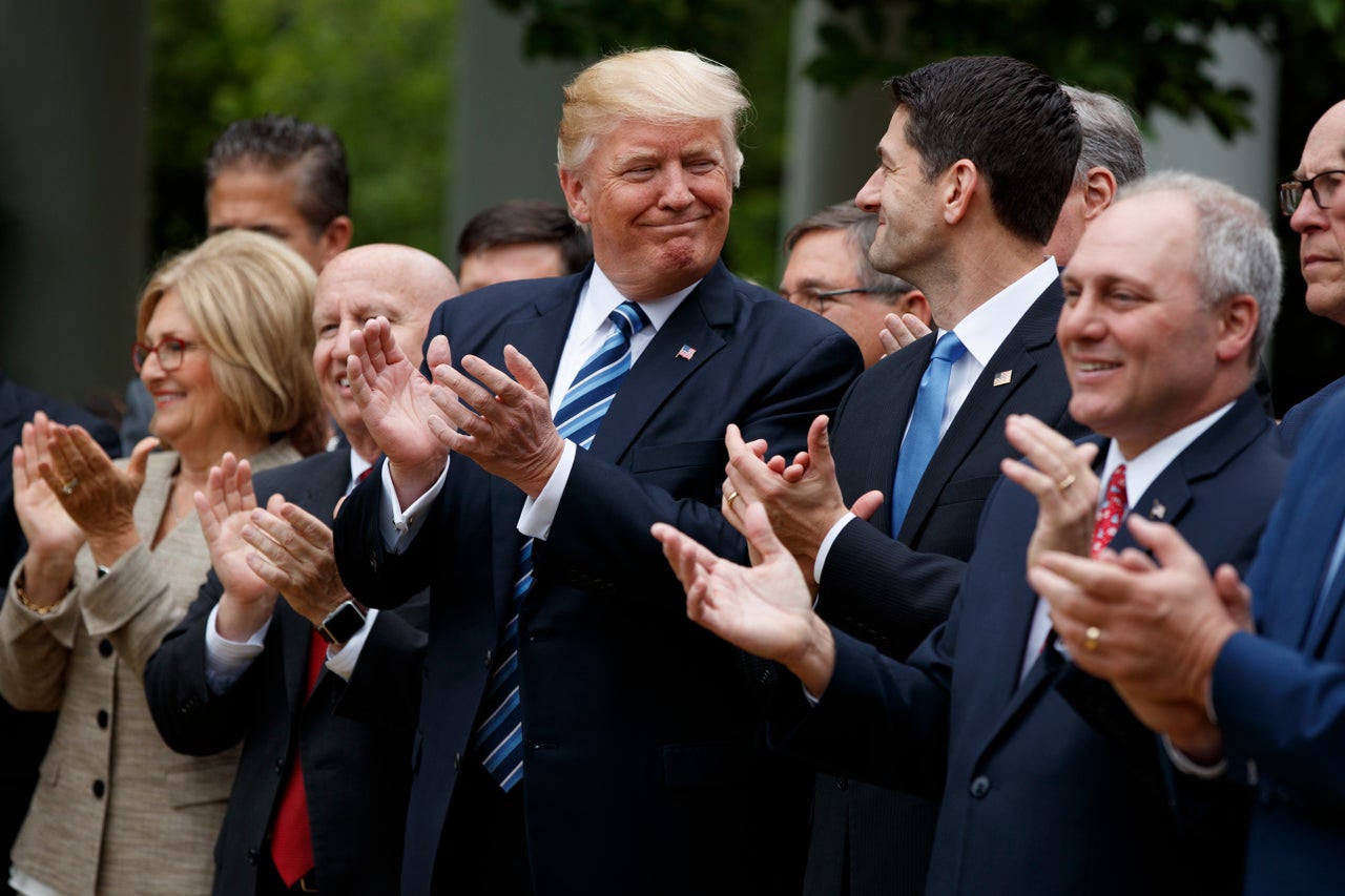 President Donald Trump and House Speaker Paul Ryan smile at each other at a celebration in the White House Rose Garden after the House pushed through a health care bill on May 4, 2017.