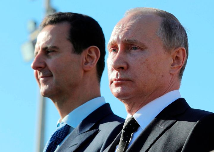 Russian President Vladimir Putin, right, and Syrian President Bashar Assad watching troops march at the Hemeimeem air base in Syria in 2017.