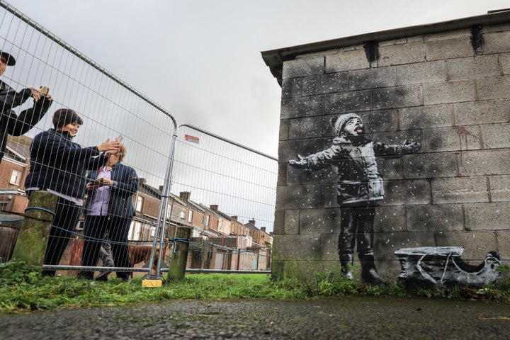 From one side, the new Banksy mural looks like a child playing in snow.