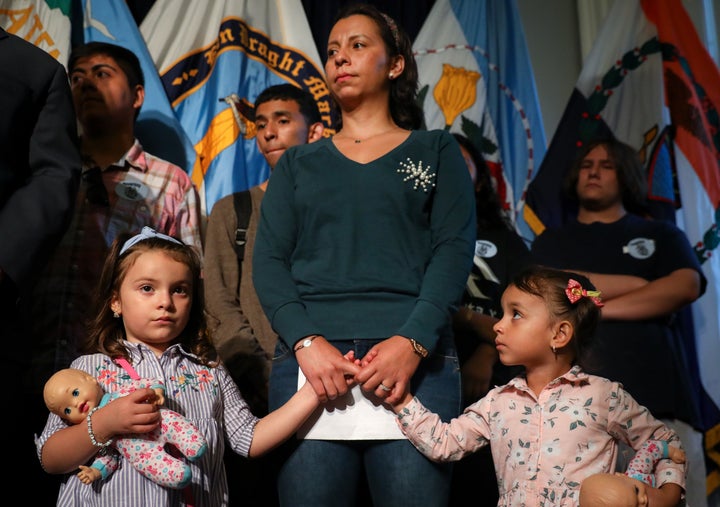 Sandra Chica holds the hands of her daughters during a rally and press conference in support of husband Pablo Villavicencio, who was detained in early June by Immigration and Customs Enforcement after making a catering delivery to Fort Hamilton Army Base in Brooklyn.