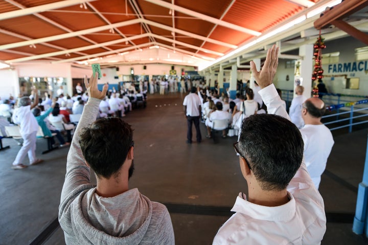 Followers of Faria pray at his "healing center" on Dec. 12.