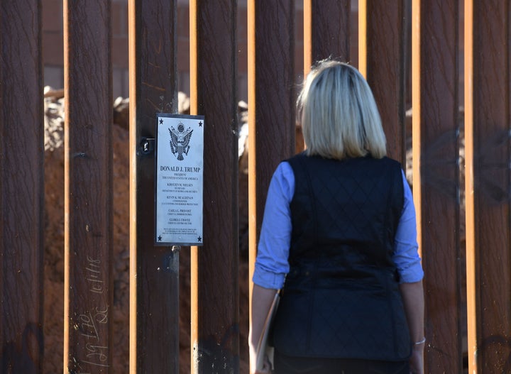 Homeland Security Secretary Kirstjen Nielsen looks at a newly renovated section of the 30-foot border fence in the El Centro