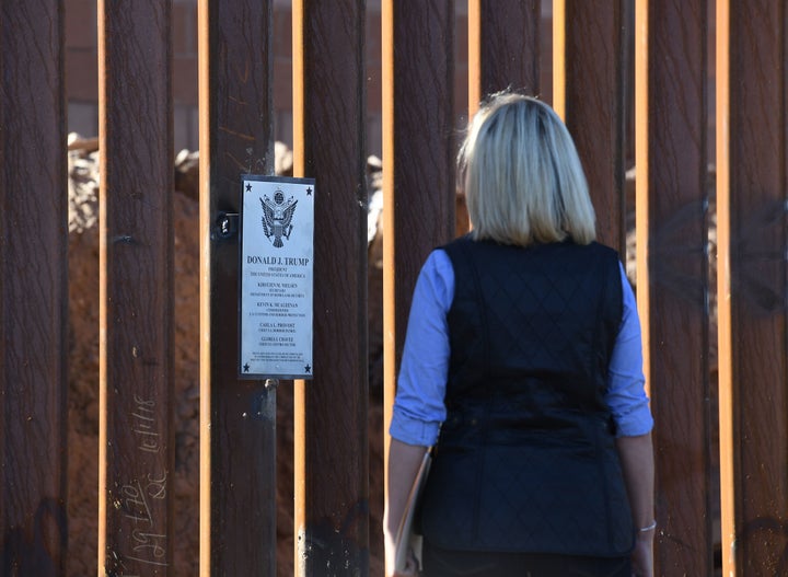 Homeland Security Secretary Kirstjen Nielsen looks at a newly renovated section of the 30-foot border fence in the El Centro sector in Calexico, California, on Oct. 26, 2018.