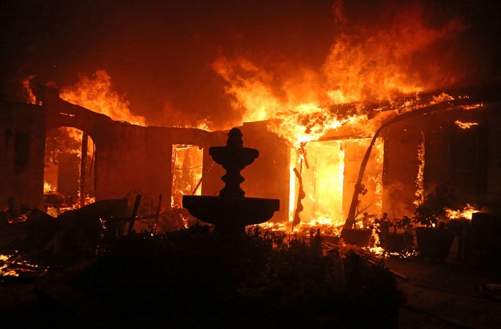 A Spanish-style home is consumed by wildfire flames on Dume Drive in Malibu, California, in November.