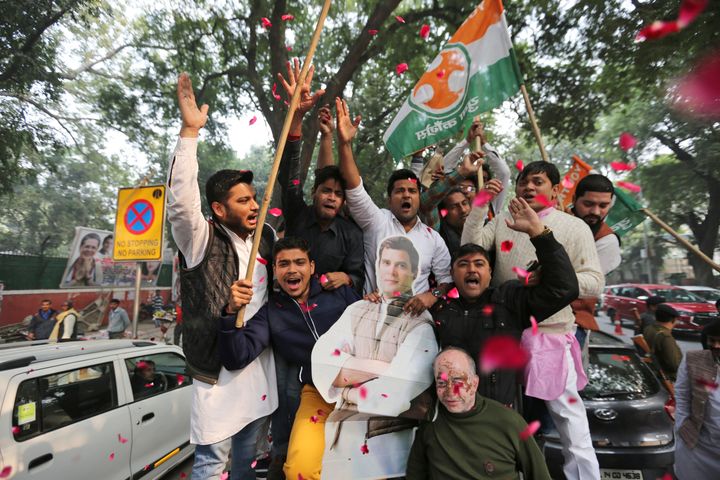 Congress party supporters hold a cut-out of party President Rahul Gandhi and celebrate outside the party headquarters in New Delhi, on 11 December 2018.