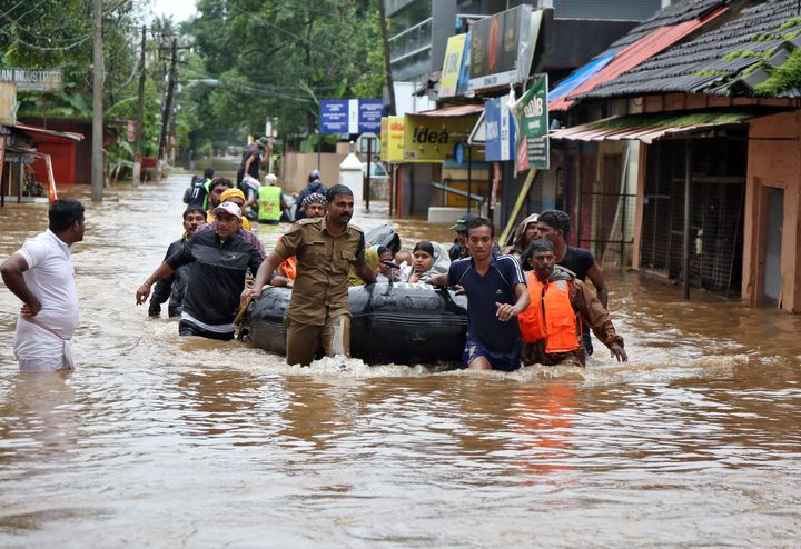 Rescuers evacuate people from a flooded area to a safer place in Aluva in Kerala, India on 18 August 2018. 