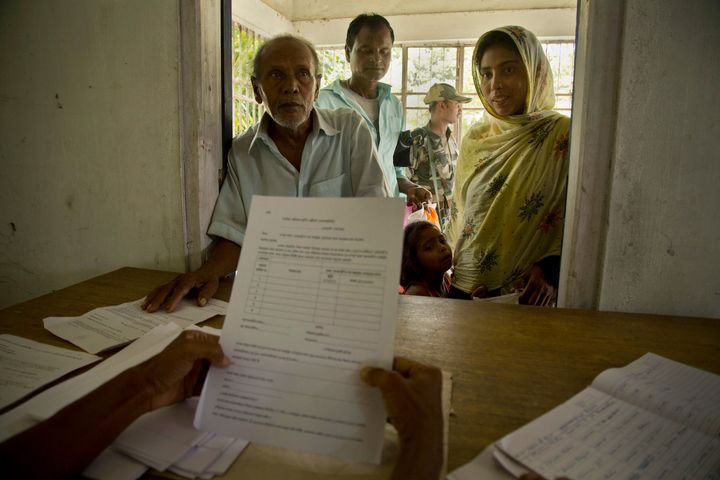 People whose names were left out in the NRC draft stand to collect forms to file appeals in Mayong, near Guwahati, on 10 August 2018. 