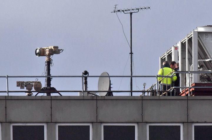 Counter-drone equipment is seen on a roof at Gatwick Airport as a police hunt for a suspect continues.