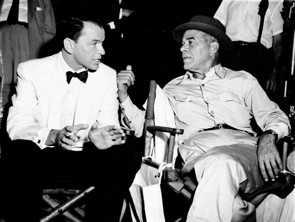 Frank Capra, right, talks with Frank Sinatra on a movie set in Hollywood on Dec. 12, 1958.