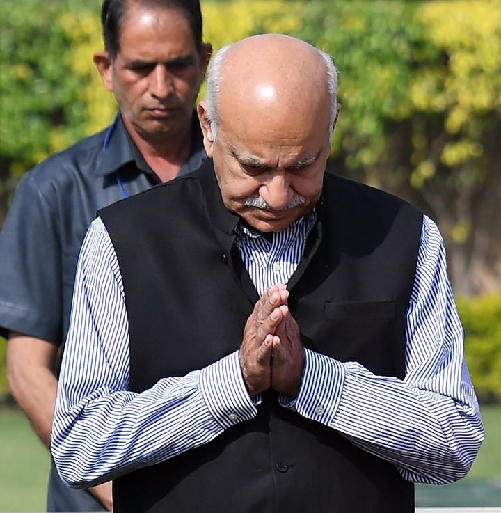 This photo taken on March 10, 2018, shows Indian Minister of State for External Affairs M. J. Akbar offering prayers while accompanying French President Emmanuel Macron and his wife Brigitte Macron to their visit to Rajghat, memorial for Mahatama Gandhi in New Delhi. India's belated #MeToo movement snowballed on October 9 after several female journalists accused Akbar of sexually harassing them. 