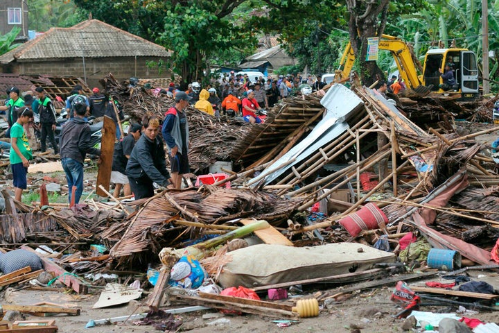 Residents inspect a house damaged by a tsunami, in Carita, Indonesia, Sunday, Dec. 23, 2018. The tsunami apparently caused by