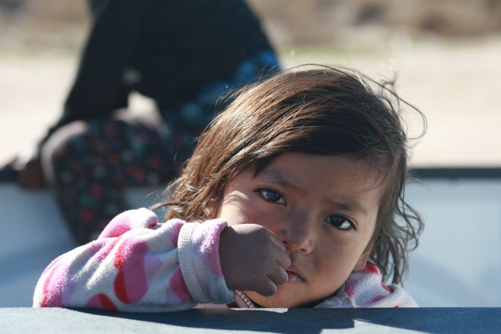 Migrant children from Guatemala cross the river with their parents in Chihuahua, Mexico, to reach the United States on Dec. 19, 2018.