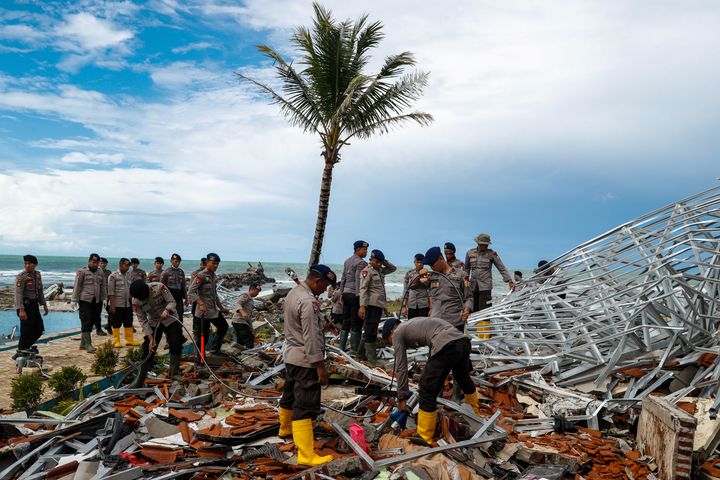 Police officers search for victims among rubble of a destroyed beach front hotel, which was hit by a tsunami in Pandeglang, Banten province, Indonesia, December 24, 2018. 