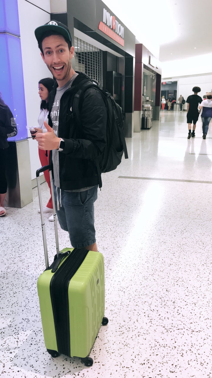 Adam at the airport lugging our stuff to a new city.