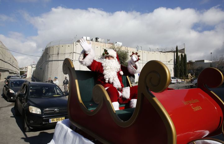 A Santa Claus on his sleigh as he arrives in the West Bank city of Bethlehem. It was believed to be the biblical West Bank city's largest Christmas celebrations in years.