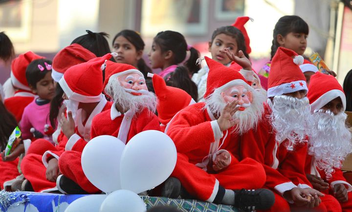 Children dressed as Santa Claus participate in a procession in Jammu, India.