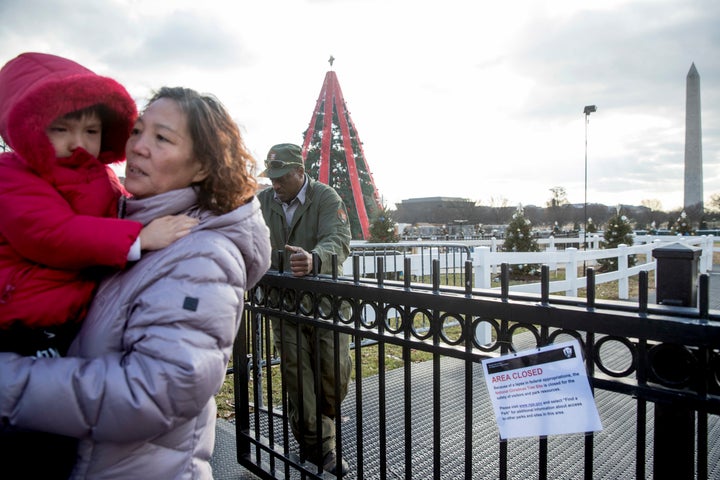A National Park Service employee closes the gate to visitors at the National Christmas Tree on the Ellipse near the White Hou
