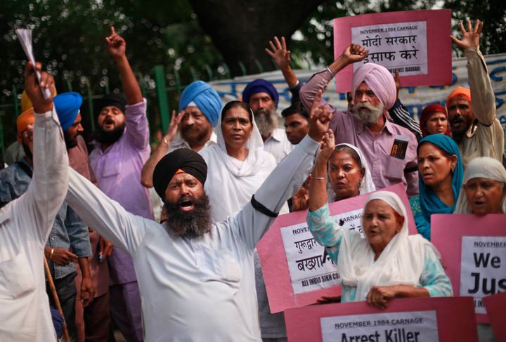 Sikhs hold placards as they shout slogans during a protest to demand justice for victims of the 1984 massacre of Sikhs.
