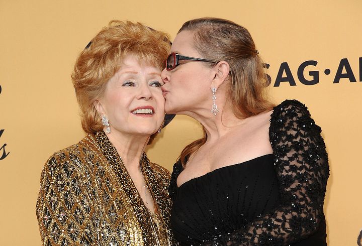 Debbie Reynolds and Carrie Fisher pose in the press room at the 21st annual Screen Actors Guild Awards on Jan. 25, 2015 in Los Angeles. 