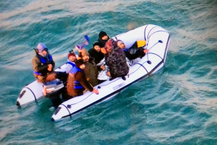 Migrants seen onboard a boat near to the French port of Calais in the English Channel earlier this week.