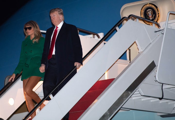 President Donald Trump and first lady Melania Trump arrive at the White House on Thursday as they return from an unannounced trip to Iraq.