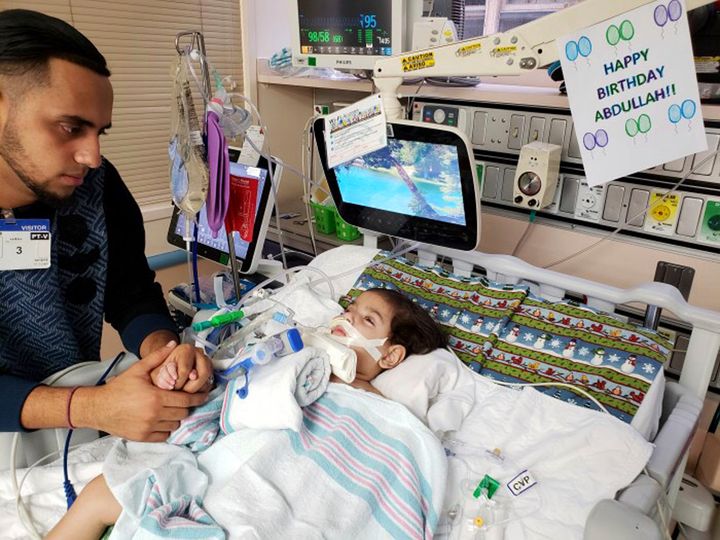 This recent undated photo shows Ali Hassan with his dying 2-year-old son Abdullah in a Sacramento hospital. 