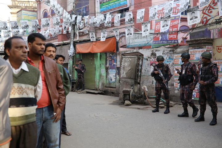 Law enforcement officials stand guard outside a voting center during the general election in Dhaka, Bangladesh, December 30, 2018. 