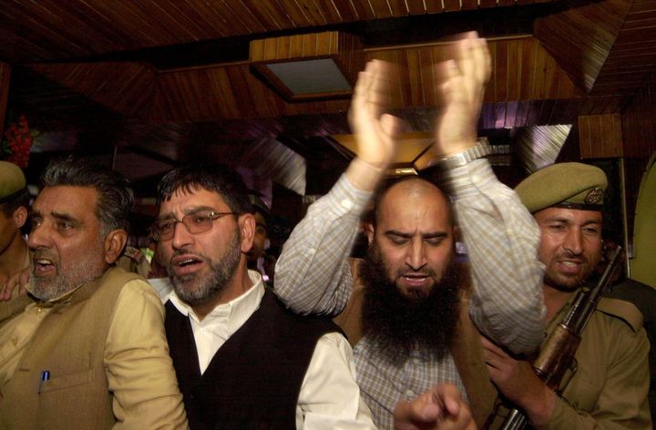 Masrat Alam (second from right) shouts slogans as he is detained by police during a press conference in Srinagar on 26 April 2007.