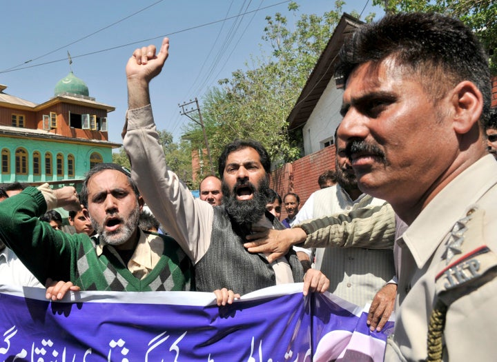 Supporters of Masrat Alam shout slogans during a protest against the slapping of PSA against him on 24 April 2015 in Srinagar.