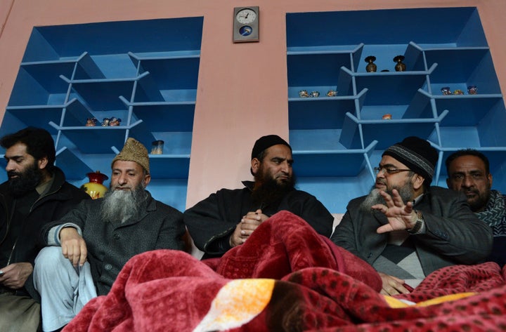 Masrat Alam (centre) speaks to visitors at his house in Srinagar on 12 March 2015.