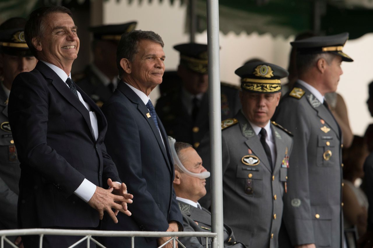 In this Dec. 1, 2018 photo, Jair Bolsonaro, left, and Minister of Defense Gen. Joaquim Silva e Luna attend a graduation ceremony at the Agulhas Negras Military Academy in Resende, Brazil. 
