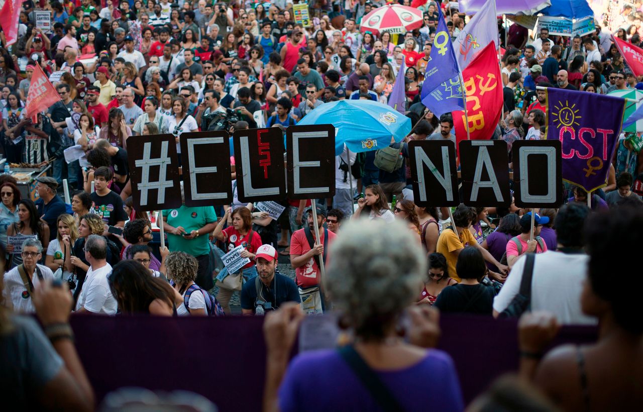 Demonstrators take part in a protest against Bolsonaro organized under the hashtag #EleNao (#NotHim), in Rio de Janeiro on Oct. 20, 2018. 