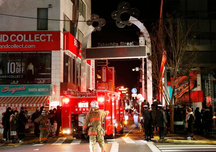 Police and firefighters inspect around the site of the car attack that left nine people injured, including one person who was punched by the driver, authorities said.