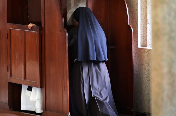 A nun partakes in the sacrament of confession at the Immaculate Heart of Mary Cathedral in Kottayam, Kerala on 4 November 2018.