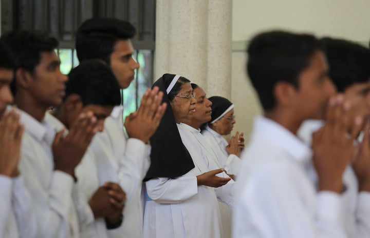 Senior nuns pray with others during Sunday mass at the Immaculate Heart of Mary Cathedral in Kottayam, Kerala.