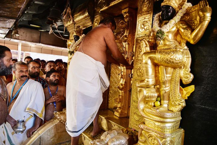 The priest closes doors at the Ayyappa shrine at the Sabarimala temple after performing 'purification' rituals following the entry of two women on 2 January 2019.