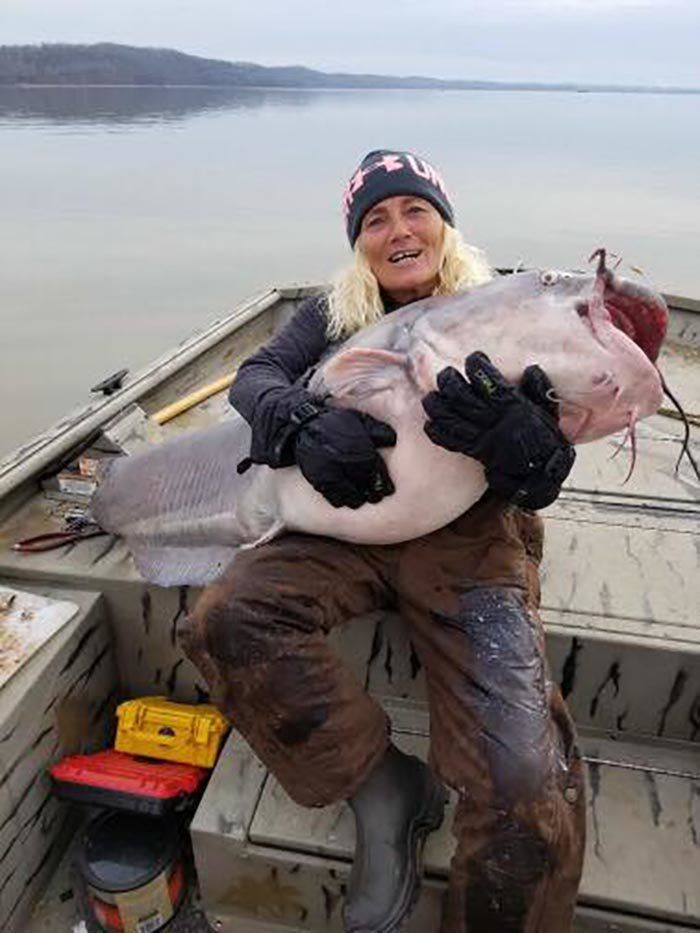 Paula Cathey Smith cradles her prize catch, an 88-pound blue catfish.