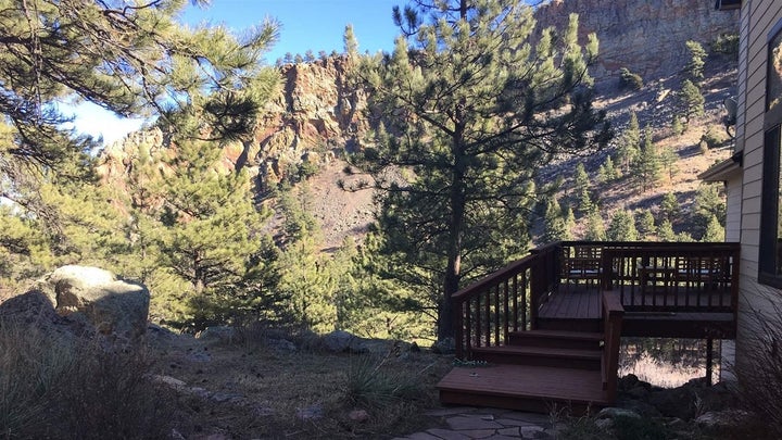 Chris Cook worked with a county program to create defensible space around his Boulder, Colorado, home, including cutting back long grass that was creeping up to the patio area. 