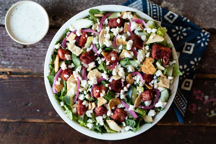 The tandoori fire salad at Just Salad is made with romaine, tandoori chicken, feta, cucumbers, pickled red onions and pita chips.