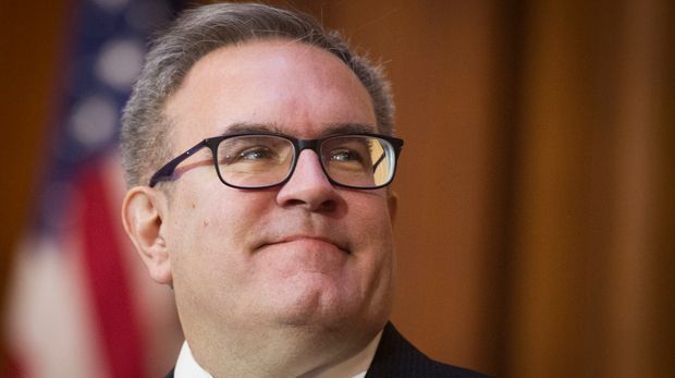 Acting EPA Administrator Andrew Wheeler signs an order withdrawing federal protections for countless waterways and wetland, at EPA headquarters in Washington, Tuesday, Dec. 11, 2018. (AP Photo/Cliff Owen)