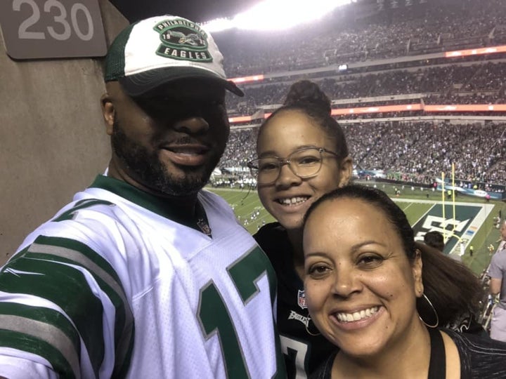 Koroun Butler, with his daughter, Naomi, and wife, Danielle, at a Philadelphia Eagles game.