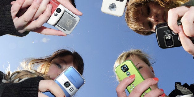 Teenagers use their mobile phones after school time in Vaasa, Finland, on March 30, 2010. AFP PHOTO / OLIVIER MORIN (Photo credit should read OLIVIER MORIN/AFP/Getty Images)